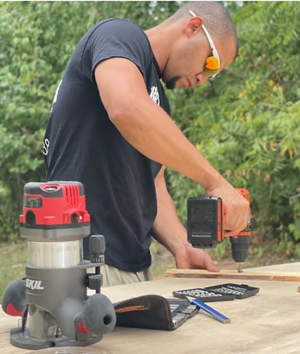 Carpenter drilling a wooden structure